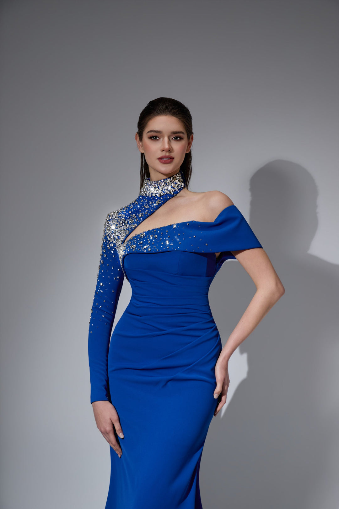 Delilah LD41039 Asymmetric One-Sleeve Sheath Gown with Crystal Collar and Ruched Waist - Blue close-up view