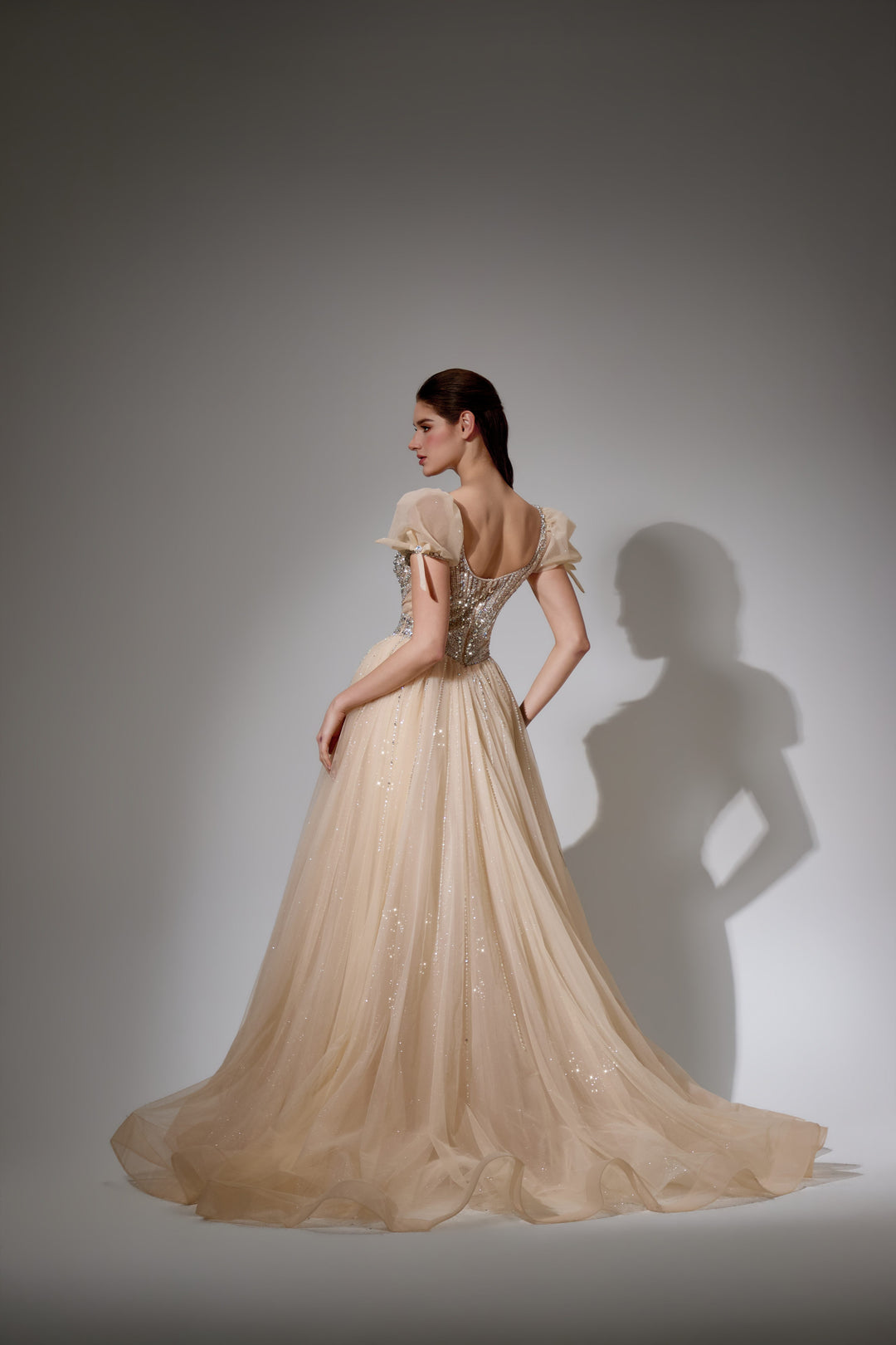Delilah SH11608 Plunging Beaded Corset Ball Gown with Puff Sleeves - Champagne back view