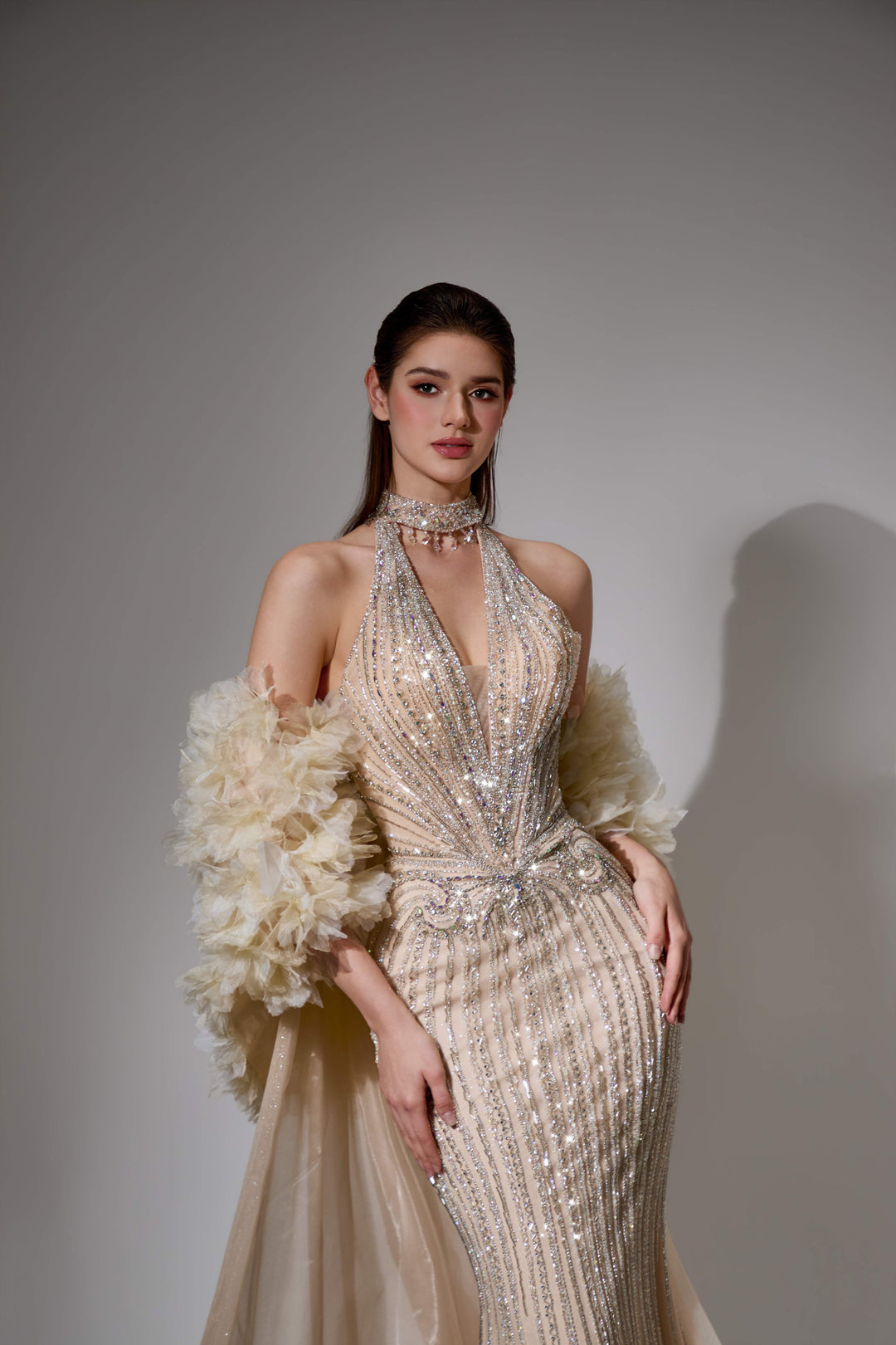 Delilah SH12045 Beaded Halter Plunging Mermaid Gown with Ruffled Arm Puffs and Overskirt - Champagne close-up view